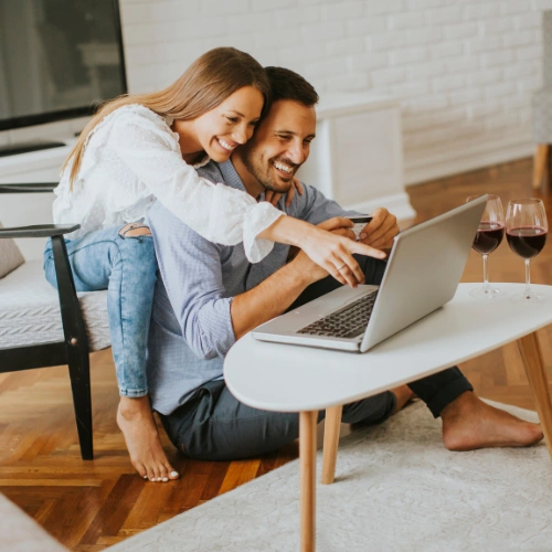 Two professionals discussing plans on a laptop